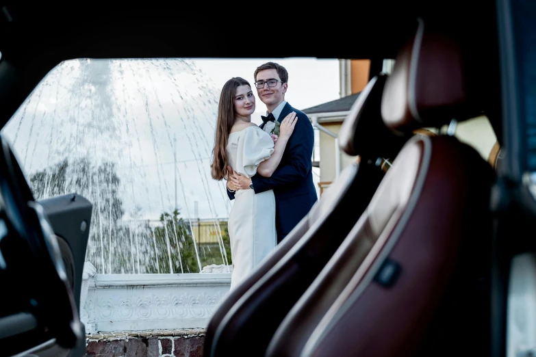 a bride and groom standing in the back of a car, a portrait, by Julia Pishtar, unsplash, renaissance, fountain in the middle, avatar image, on a super yacht, taken with canon 5d mk4