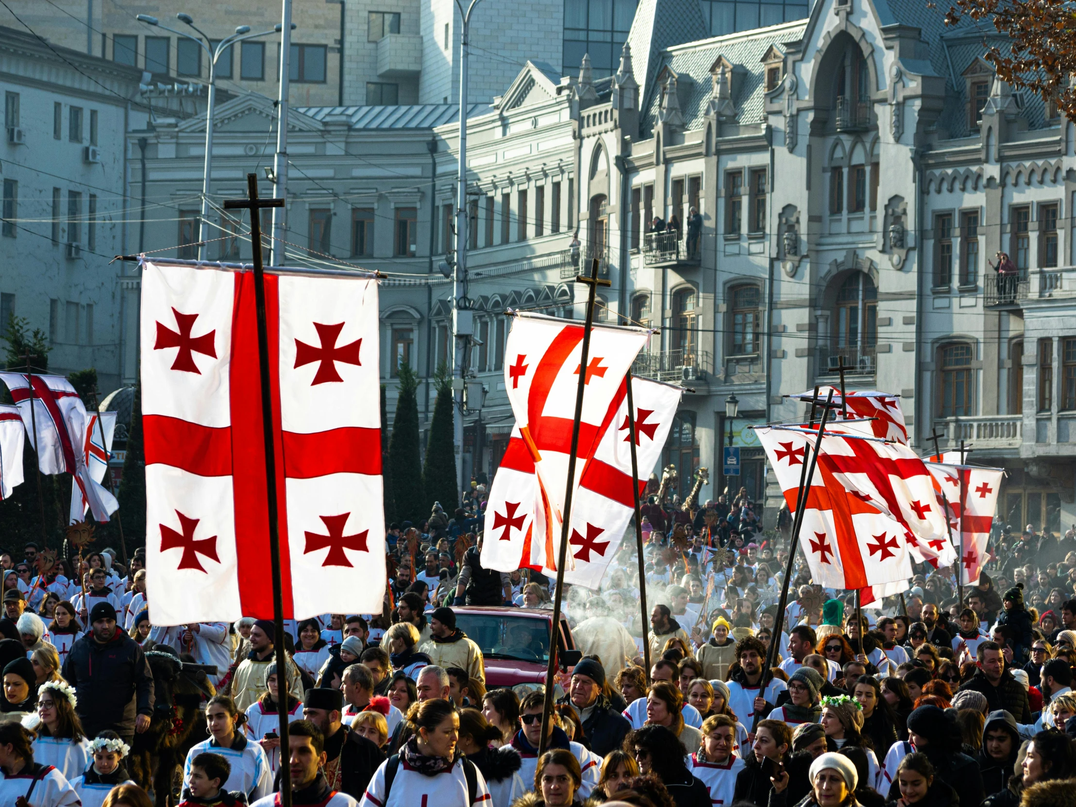 a crowd of people walking down a street holding flags, by Arthur Sarkissian, shutterstock, renaissance, templar, square, georgic, 2 0 0 2 photo