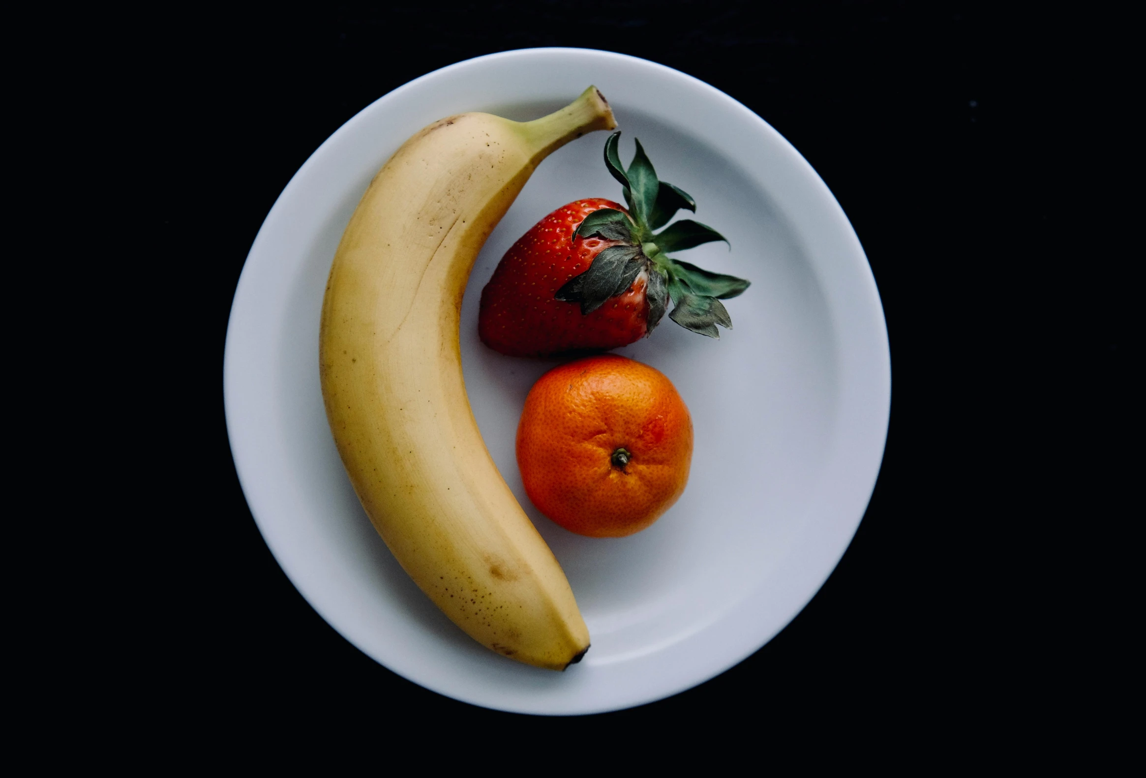 a banana and an orange on a plate, by Matthias Stom, unsplash, hyperrealism, taken in 1 9 9 7, multi - coloured, white, fruits