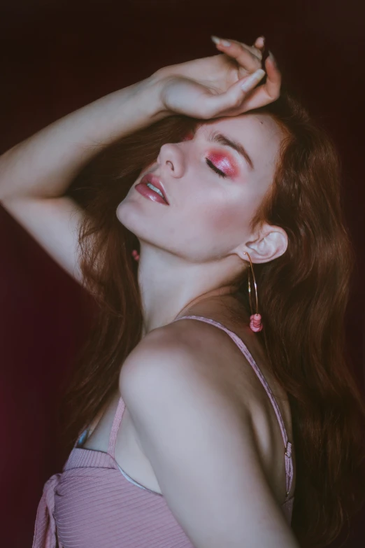 a woman with long red hair wearing a pink dress, an album cover, inspired by Elsa Bleda, trending on pexels, photorealism, long earrings, red eyed, pale woman, trending on imagestation