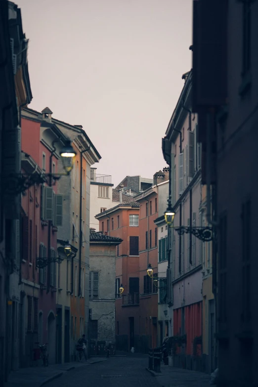 a couple of people walking down a street next to tall buildings, inspired by Carlo Maderna, unsplash contest winner, renaissance, beautiful small town, muted pastel colors, payne's grey and venetian red, view from the street