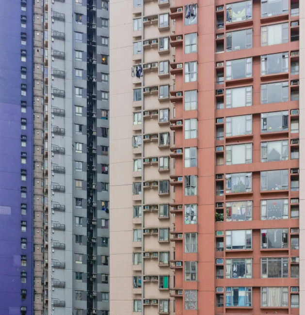 a group of tall buildings next to each other, a photo, inspired by Zhang Kechun, pexels, hyperrealism, some red and purple, neighborhood outside window, pastels, photographed for reuters