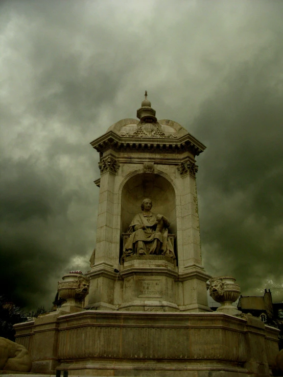 a statue sitting on top of a fountain under a cloudy sky, pexels contest winner, neoclassicism, dome, dark eerie photograph, square, parce sepulto