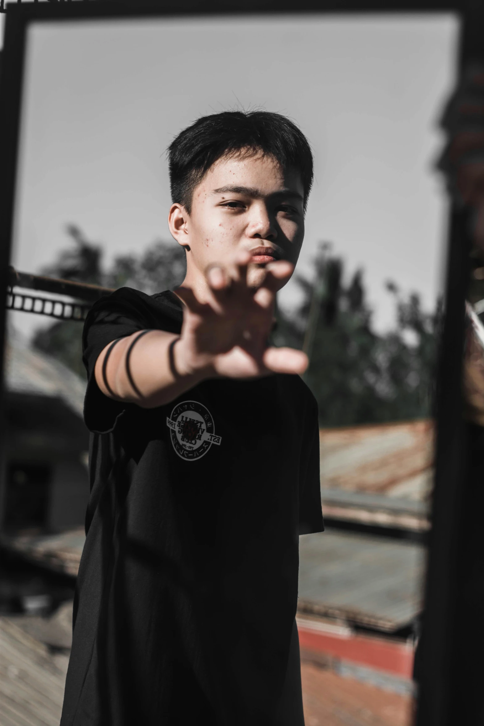 a man holding a baseball bat in front of a mirror, inspired by Gang Hui-an, pexels contest winner, wearing a black tshirt, confident action pose, outdoor photo, avatar image