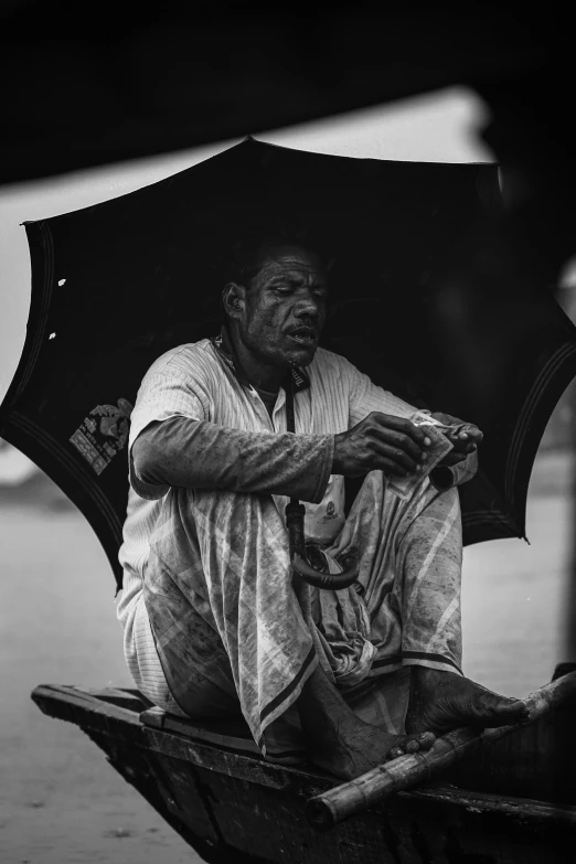 a man sitting in a boat holding an umbrella, heavy contrast, ((portrait)), street vendors, portrait featured on unsplash