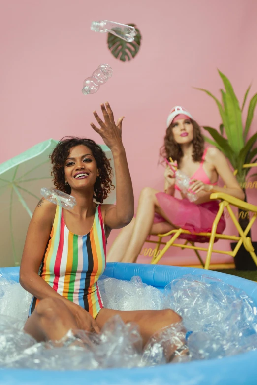 two women playing with bubbles in an inflatable pool, an album cover, shutterstock, 5 0 0 px models, backdrop, portrait mode photo, parade floats