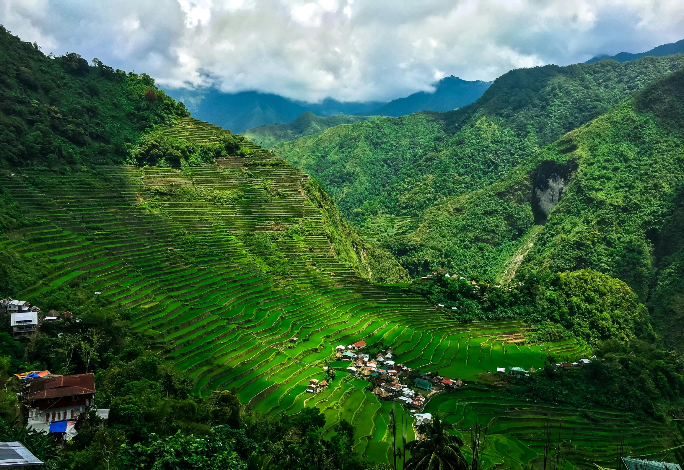 a valley filled with lots of green grass, by Jessie Algie, pexels contest winner, sumatraism, philippines, terraced, brightly lit, festivals