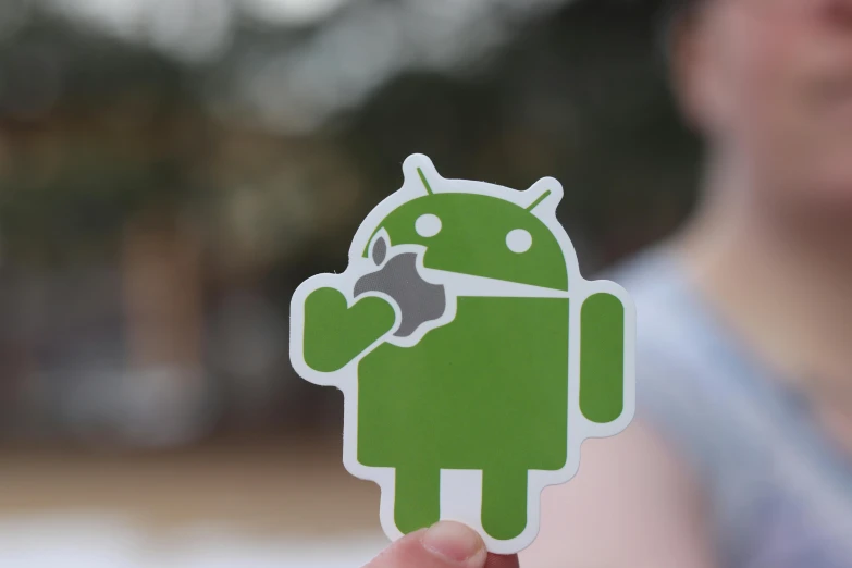 a person holding a green android sticker in their hand, unsplash, square, various posed, chocolate, white