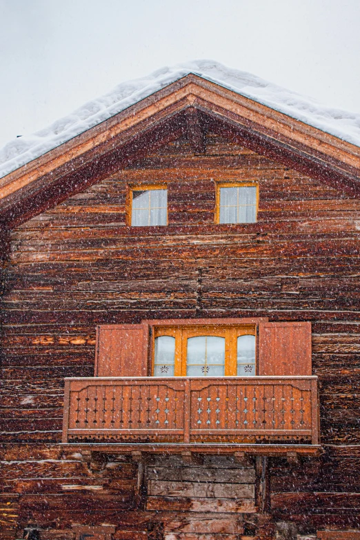 a wooden house with a balcony in the snow, inspired by Peter Zumthor, pexels contest winner, renaissance, warm cosy colors, multicolored, full frame image, brown