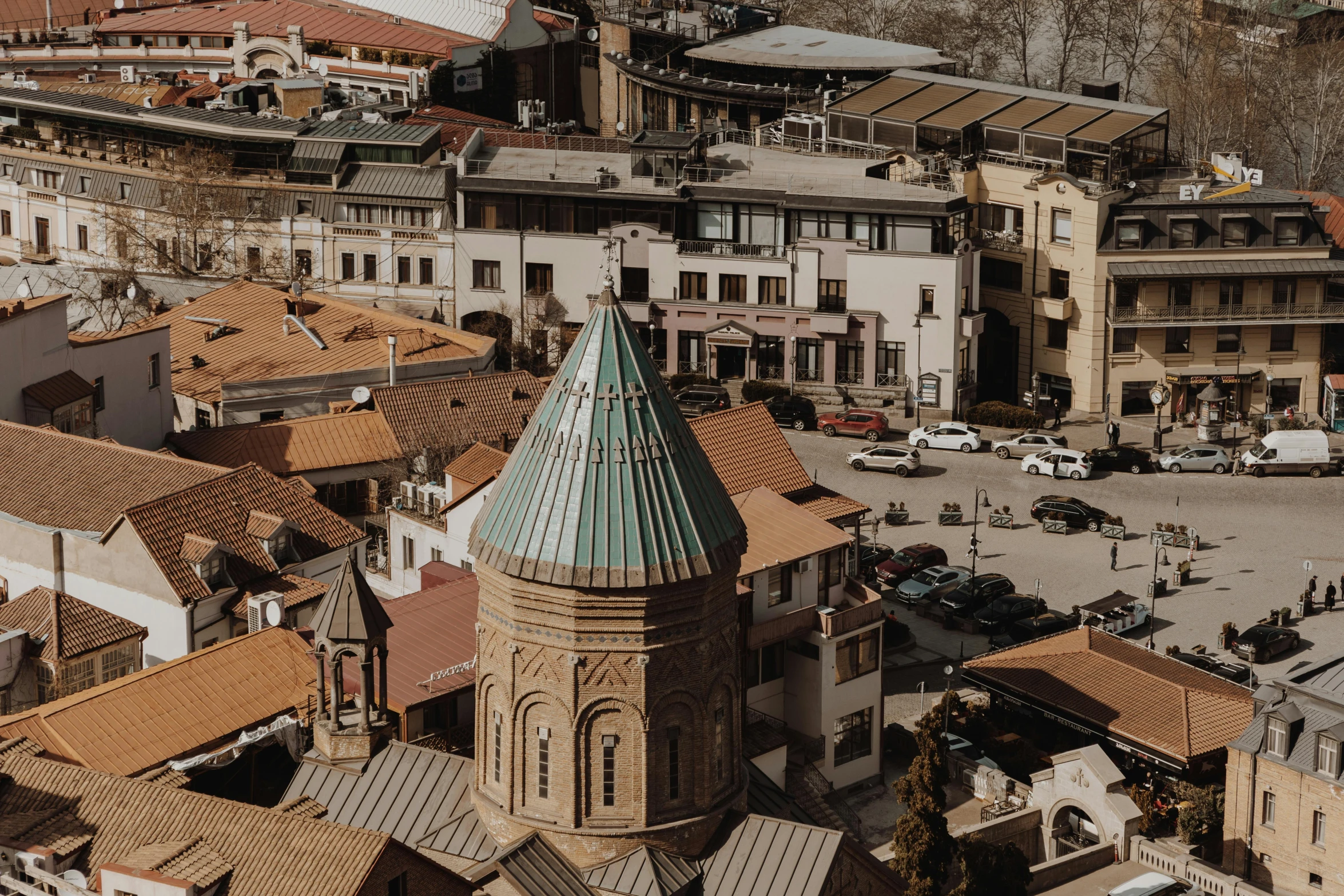 an aerial view of a city with a clock tower, pexels contest winner, ayanamikodon and irakli nadar, rounded roof, brown, georgic