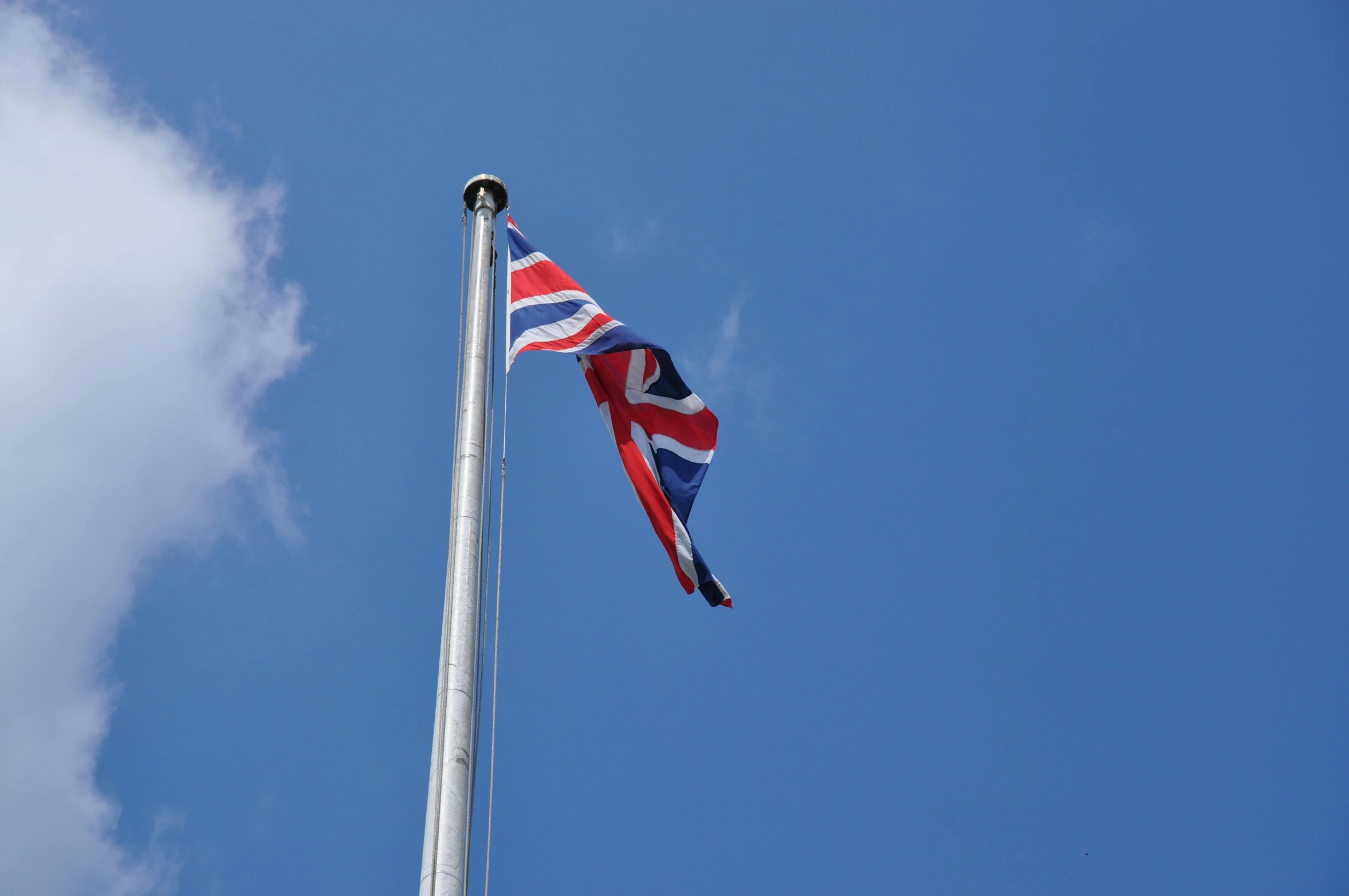 a british flag flying high in the sky, unsplash, square, reykjavik, taken in the late 2010s, high quality photo