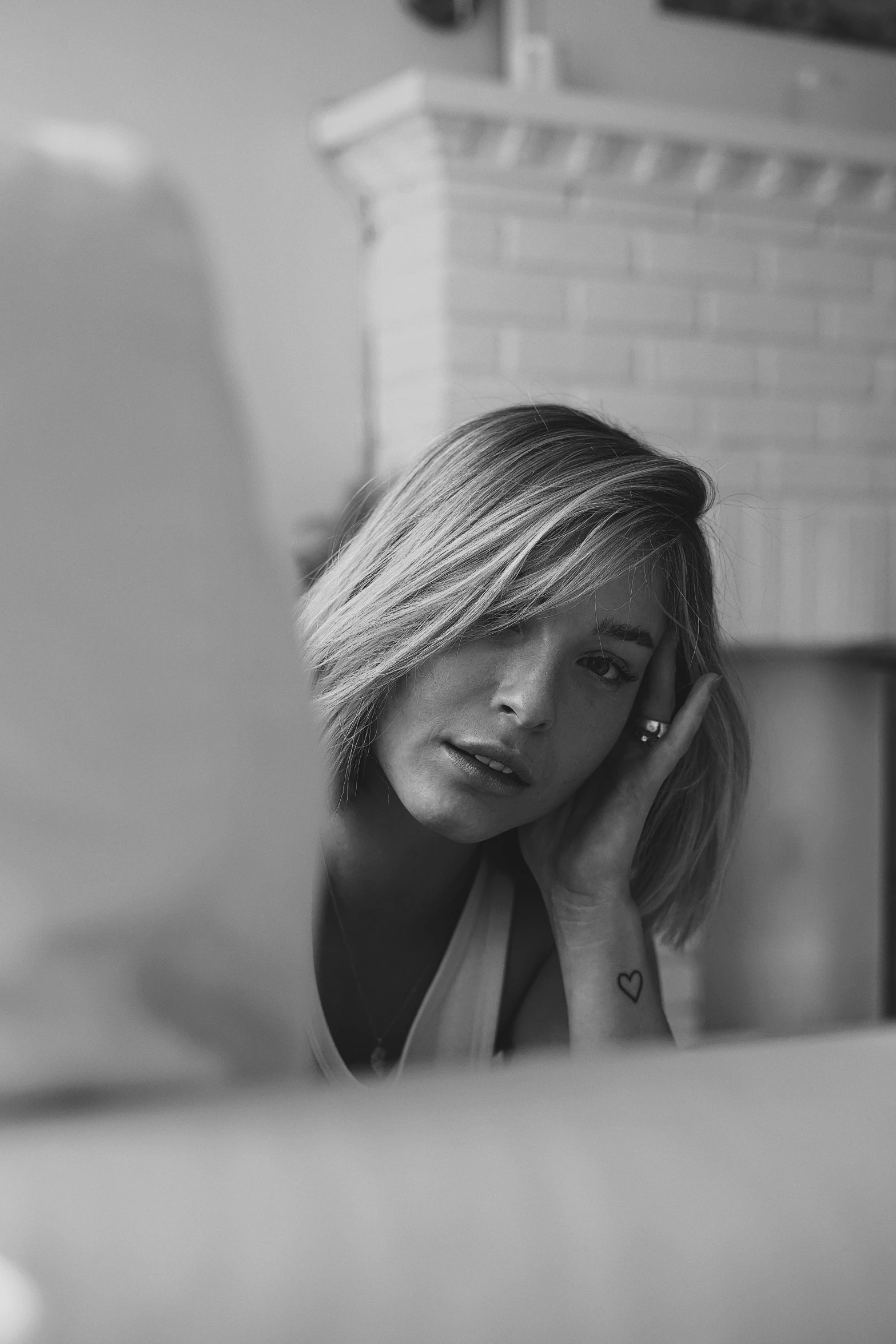 a woman sitting in front of a laptop computer, a black and white photo, by Augustyn Mirys, reddit, photorealism, chloe bennet, young blonde woman, dreamy feeling, :: morning