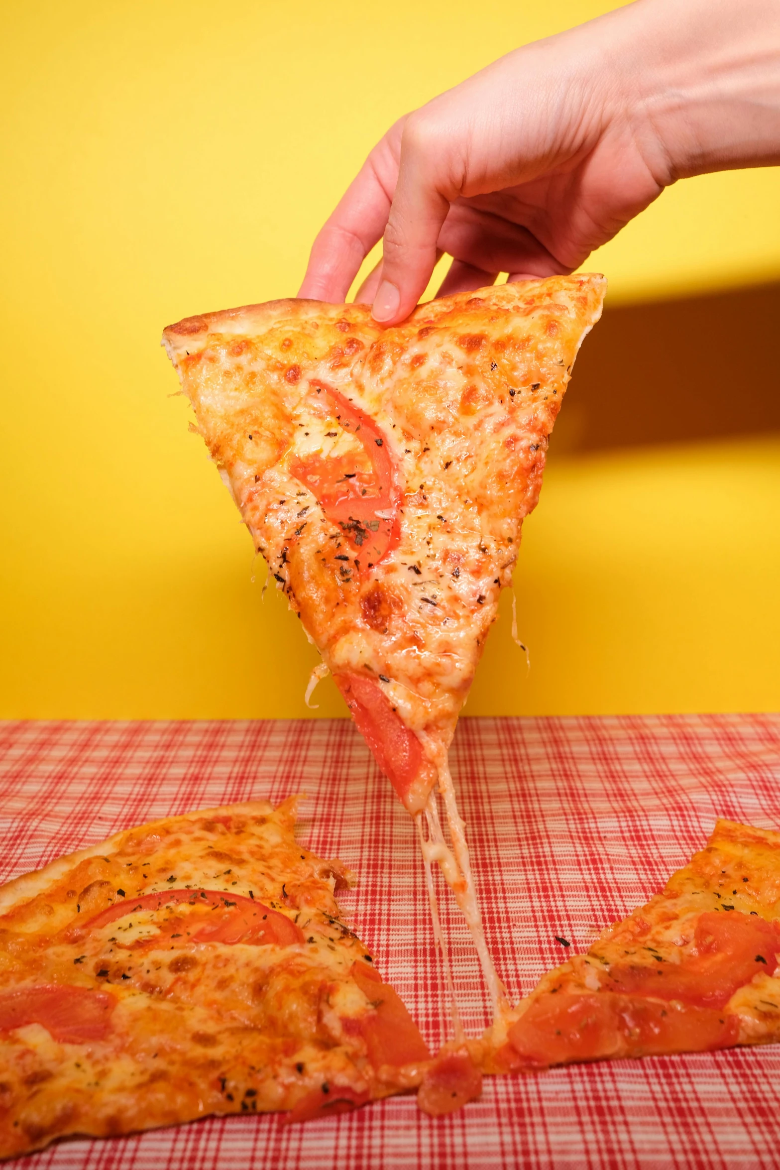 a person taking a slice of pizza from a table, speckled, real life size, large)}], tall angle