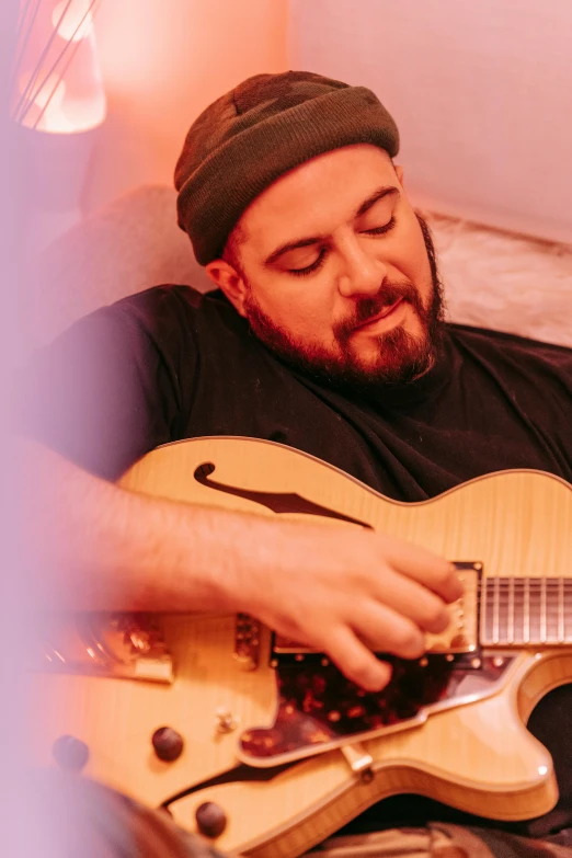 a man with a beard playing a guitar, dany devito, coloured photo, josh black, curves