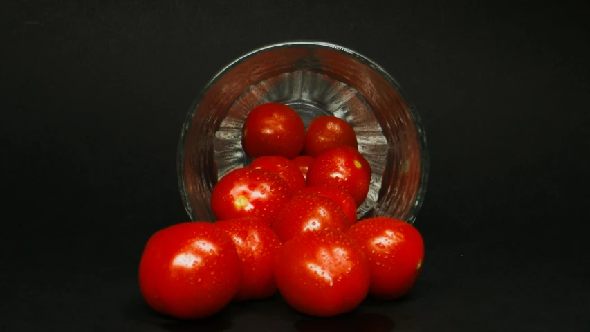 a glass jar filled with tomatoes on top of a table, pixabay contest winner, hyperrealism, bowl, lighting refraction, amateur photograph, with a black background