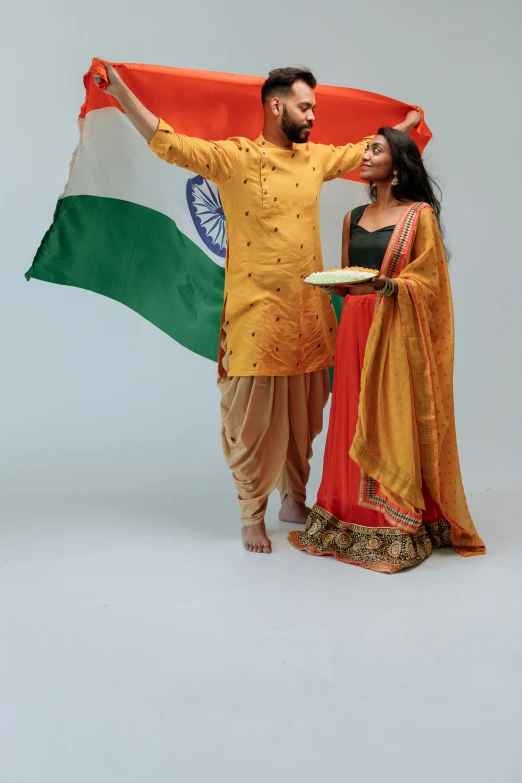 a man and a woman holding an indian flag, an album cover, pose 4 of 1 6, ( ( theatrical ) ), diverse outfits, 15081959 21121991 01012000 4k