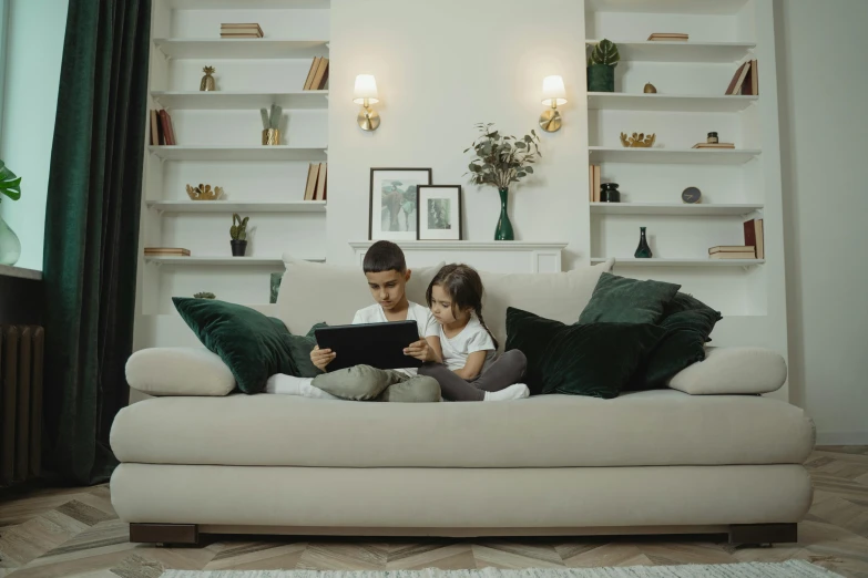 a couple of kids sitting on top of a couch, pexels, reading nook, netflix animation, elegant design, small room