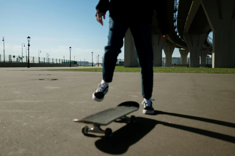 a person riding a skateboard in a parking lot, by Matthias Stom, slightly sunny weather, eye - level medium - angle shot, low quality photo, cinematic shot ar 9:16 -n 6 -g