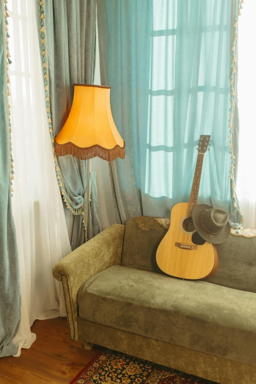 a guitar sitting on top of a couch in a living room, inspired by Maxwell Gordon Lightfoot, art nouveau, draped drapes, yellow and cyan color palette, studio ambient lighting, hotel room