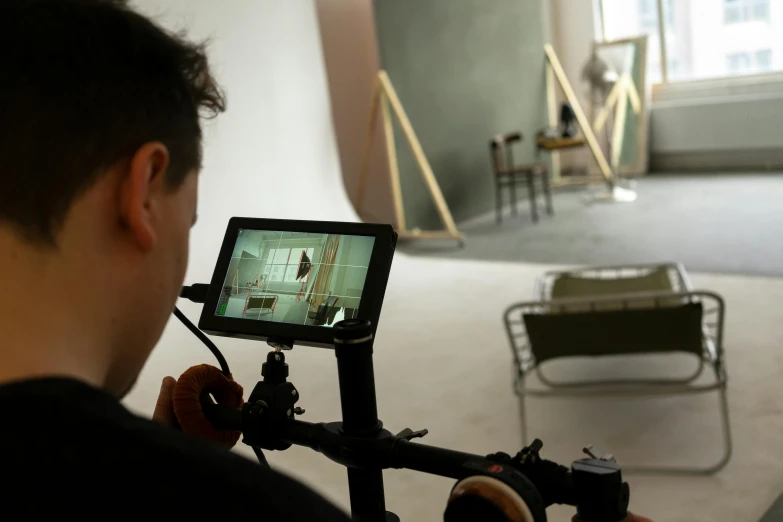 a man that is standing in front of a camera, by Matthias Stom, instagram, video art, in a studio, foreground, ignant, product shoot