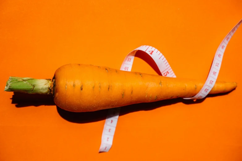 a carrot with a measuring tape wrapped around it, unsplash, magic realism, sacral chakra, 🦩🪐🐞👩🏻🦳, epicurious, competition winning