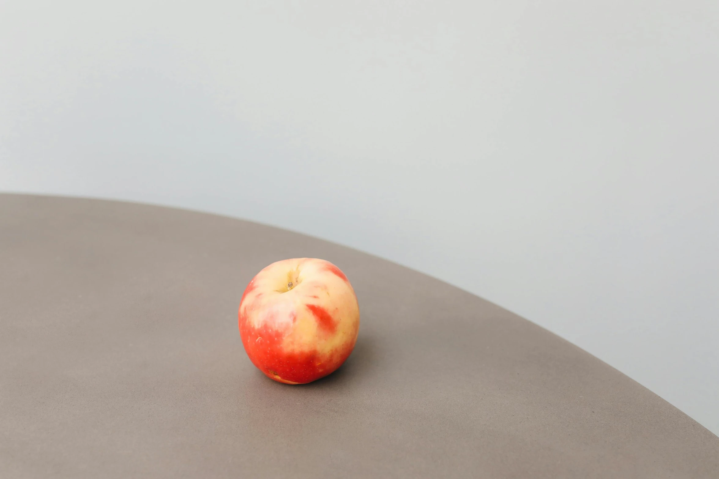 a red apple sitting on top of a table, by Harvey Quaytman, smooth solid concrete, peach, small