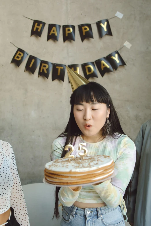 a woman blowing out candles on a birthday cake, an album cover, pexels contest winner, half asian, 2 5 year old, 🍸🍋, 2 5 6 x 2 5 6 pixels