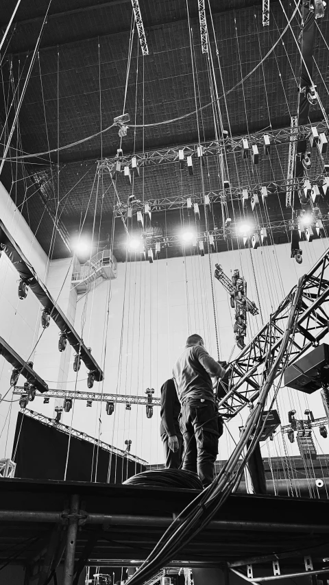 a group of men standing on top of a stage, by Stan Galli, fluxus, hanging cables, behind the scenes photo, 1 9 6 0's sci - fi, getty images