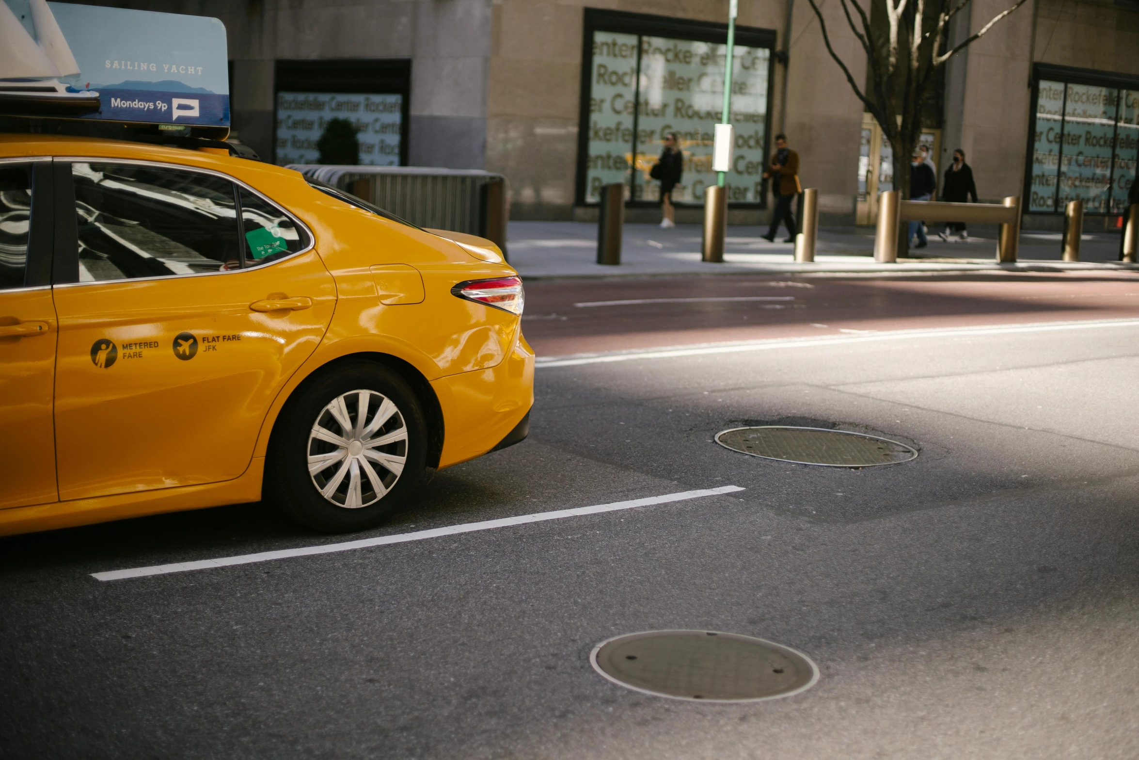 a yellow taxi cab driving down a city street, pexels contest winner, square, ground - level medium shot, low quality photo, street corner