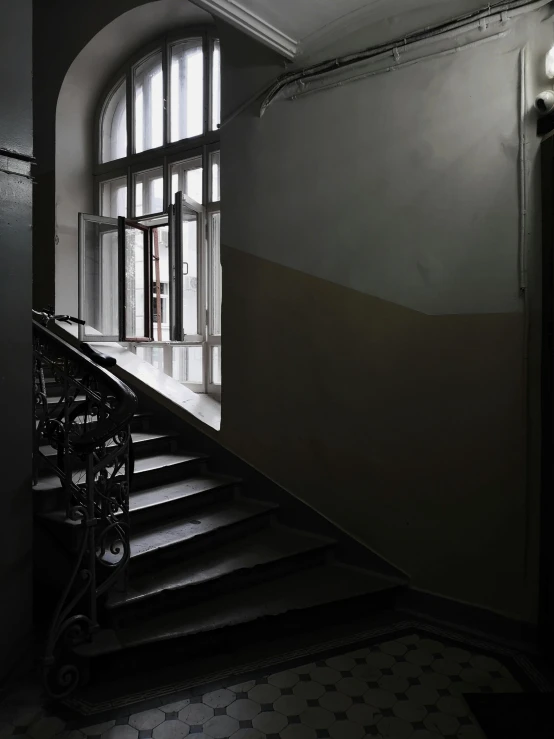 a black and white photo of a staircase, inspired by Katia Chausheva, apartment of an art student, doorway, dark colour scheme, inside a museum