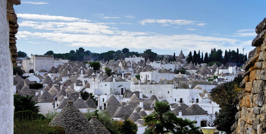 a view of a town from the top of a hill, pexels contest winner, renaissance, trulli, white sweeping arches, brown, grey