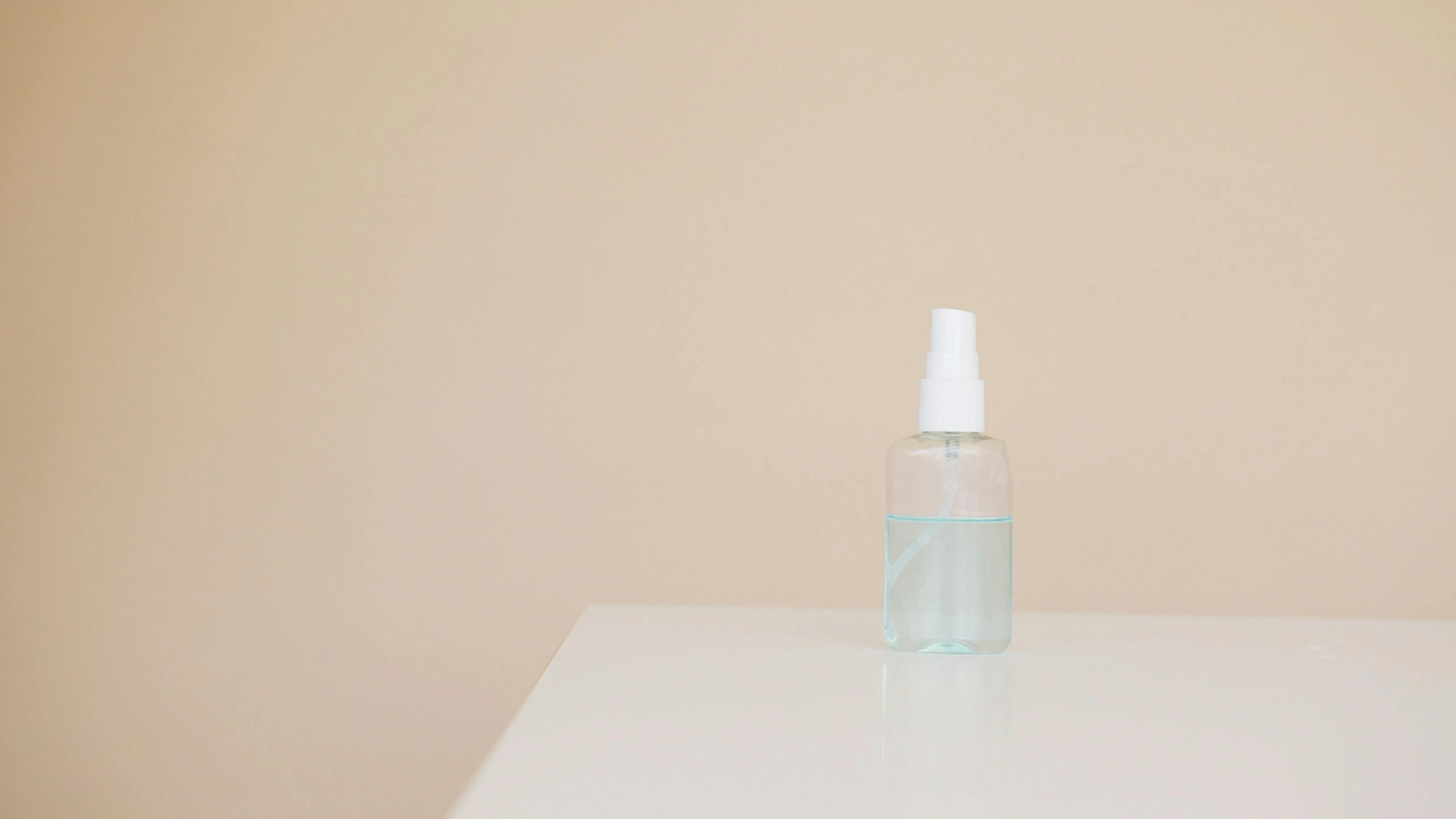 a bottle of water sitting on top of a table, by Nicolette Macnamara, minimalism, acne, sprays, without text, clean room