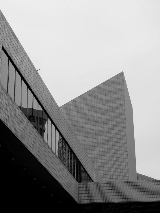 a black and white photo of a building, by Christen Dalsgaard, angled walls, by greg rutkowski, pyramid, alvar aalto