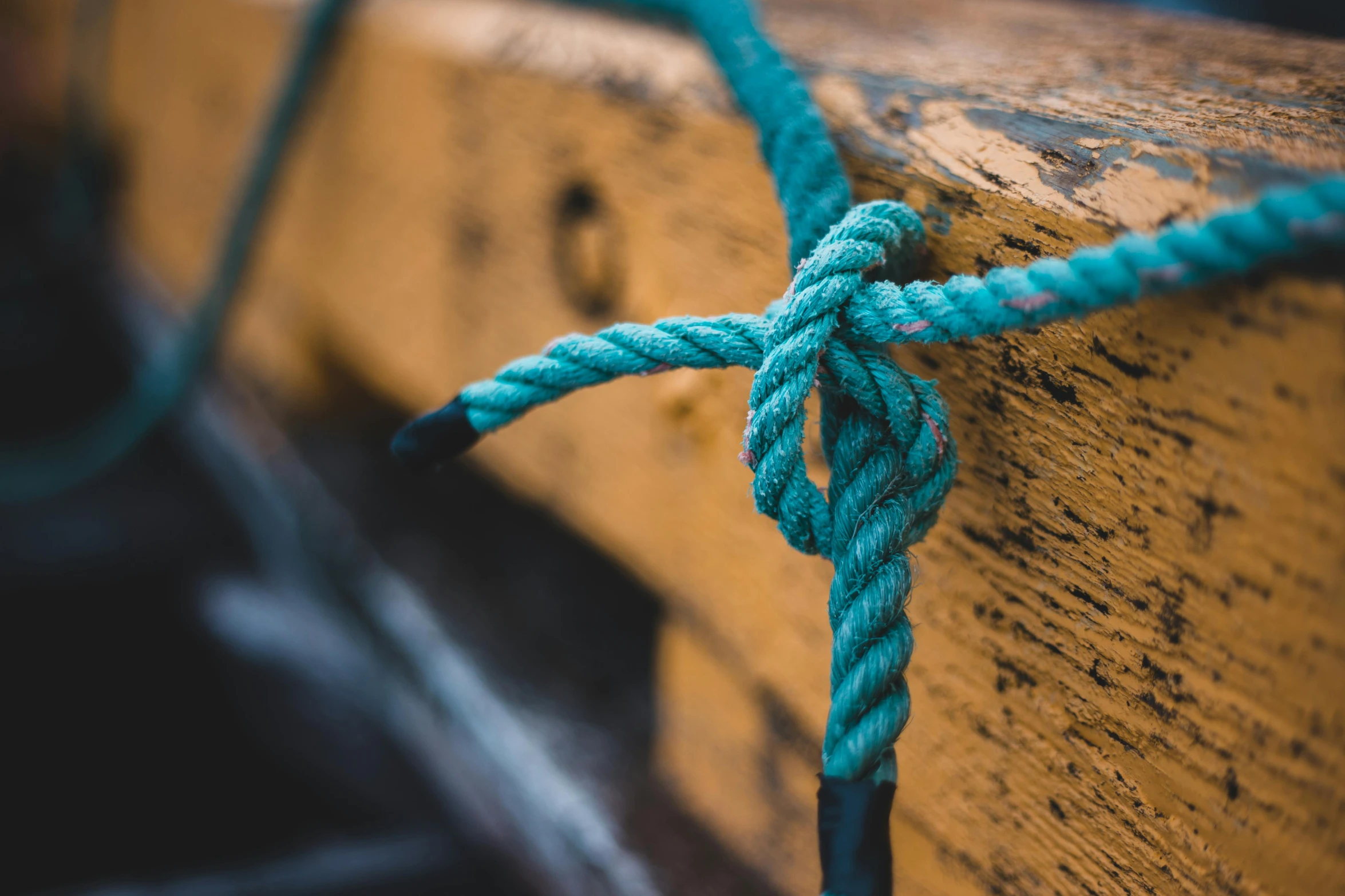 a close up of a rope on a boat, a photo, trending on pexels, graffiti, a wooden, teal, 🦩🪐🐞👩🏻🦳, thumbnail