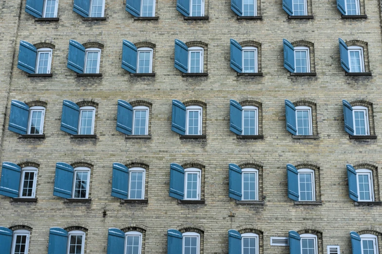 a tall brick building with blue shutters on the windows, pexels contest winner, in rows, fake windows, lynn skordal, computer wallpaper