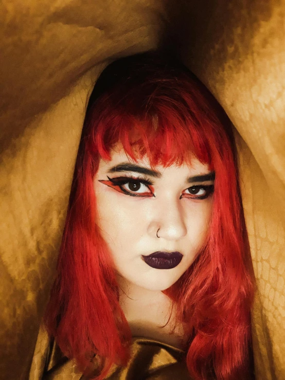 a close up of a person with red hair, an album cover, inspired by Elsa Bleda, trending on pexels, lowbrow, witch's hat, with gold eyes, 1 7 - year - old goth girl, red ocher