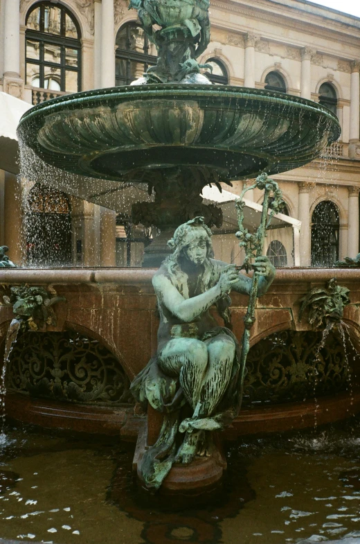 a fountain with a statue sitting on top of it, vienna state opera house, alessio albi, courtyard, bronze