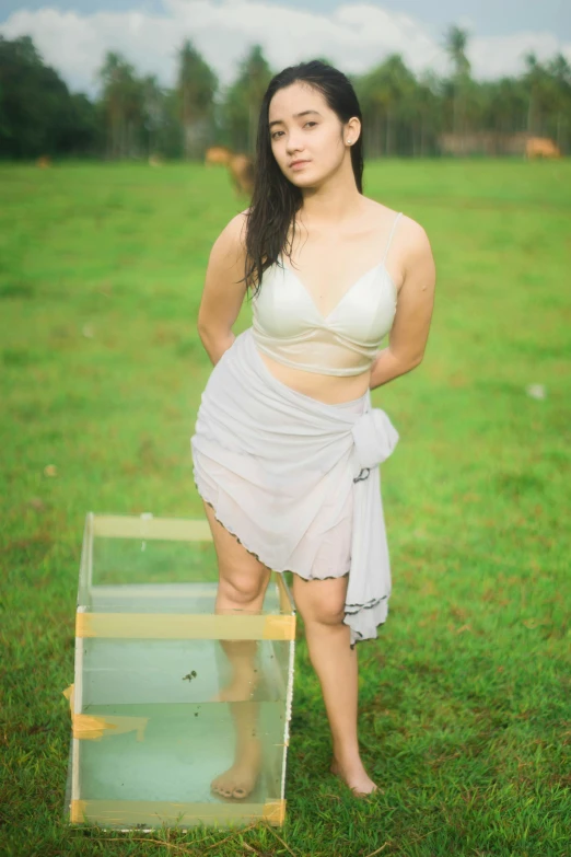 a woman posing for a picture in a field, by Basuki Abdullah, conceptual art, cottagecore!! fitness body, translucent white skin, desi, bra