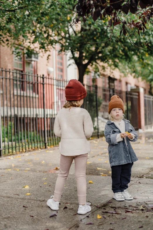 a couple of kids standing next to each other on a street, by Anita Malfatti, pexels, wearing wool hat, brooklyn, muted fall colors, 15081959 21121991 01012000 4k