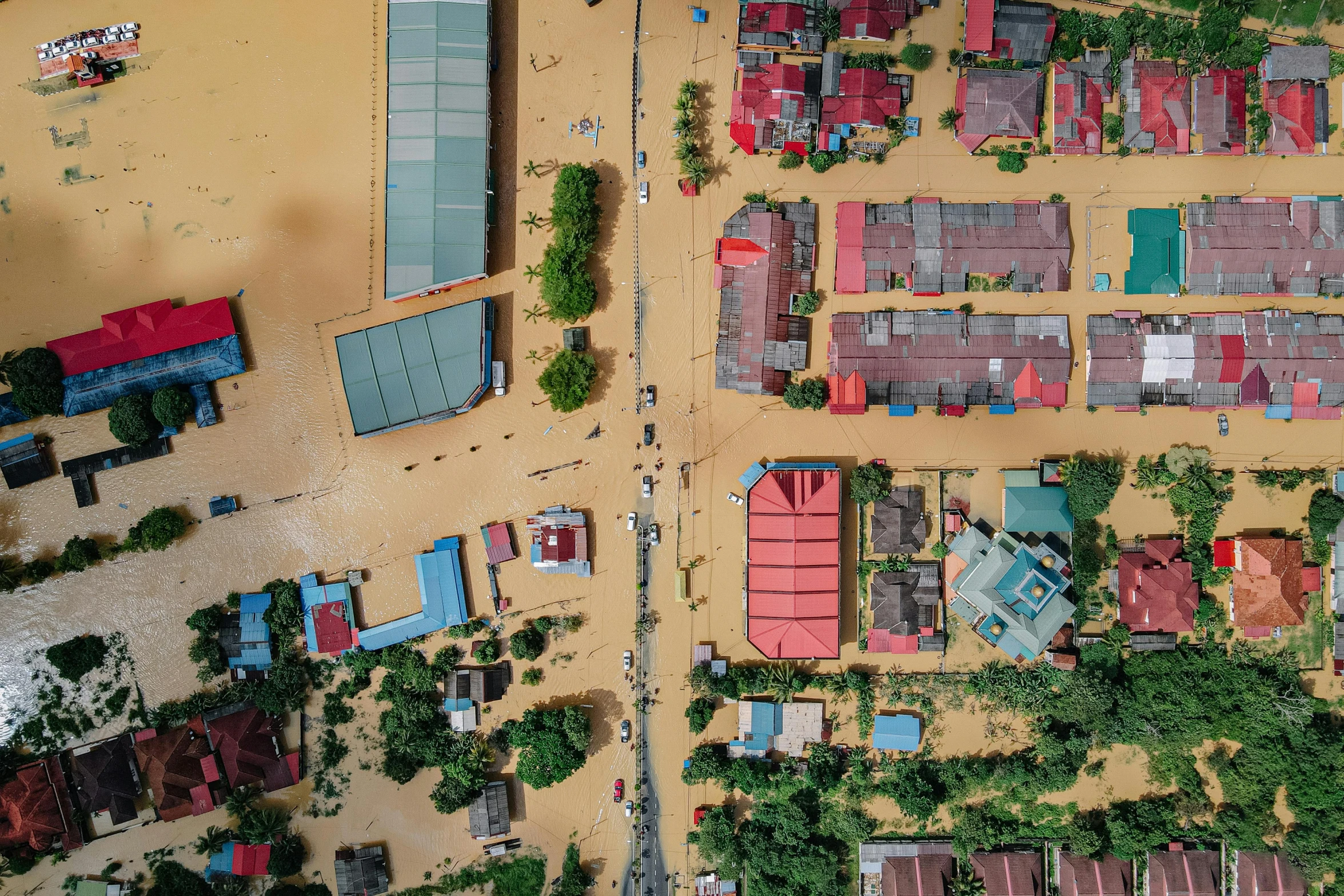 a group of houses sitting on top of a sandy beach, shutterstock, hurufiyya, flooded station, top-down shot, tan, jakarta