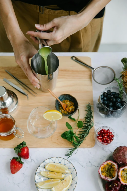 a close up of a person preparing food on a table, mixing drinks, botanical, profile image, curated collections