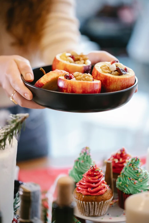 a close up of a person holding a plate of food, candy apple, ornament, peach, customers