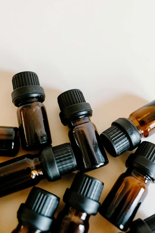 a bunch of bottles sitting on top of a table, by Gavin Hamilton, trending on pexels, brown robes, salvia, black oil, profile image