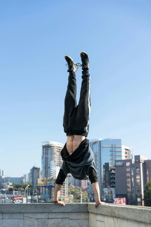 a man doing a handstand in front of a city skyline, happening, lachlan bailey, greg broadmore, full body 8k, heavily upvoted