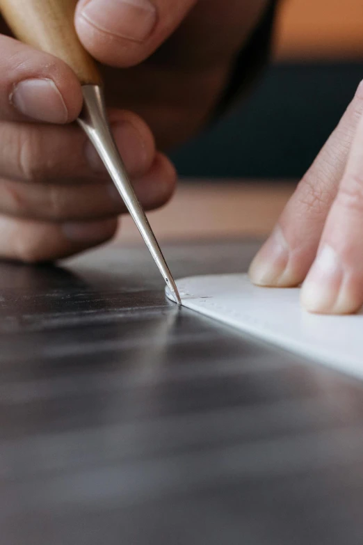 a person cutting a piece of paper with a pair of scissors, a photorealistic painting, inspired by Hiromitsu Takahashi, trending on pexels, hyperrealism, carved in marble, white ink, graphic detail, writing a letter