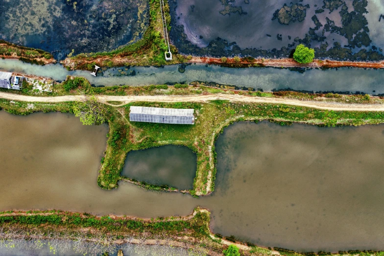 an aerial view of a large body of water, an album cover, by Jan Tengnagel, unsplash, wide view of a farm, bioremediation, canal, 15081959 21121991 01012000 4k