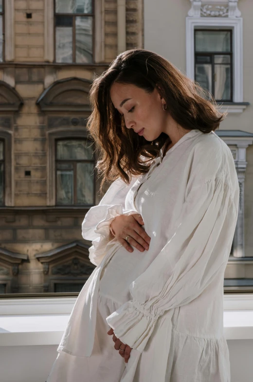 a pregnant woman in a white dress standing on a balcony, pexels contest winner, baroque, wearing a linen shirt, olga kurylenko, robe. extremely high details, the birth