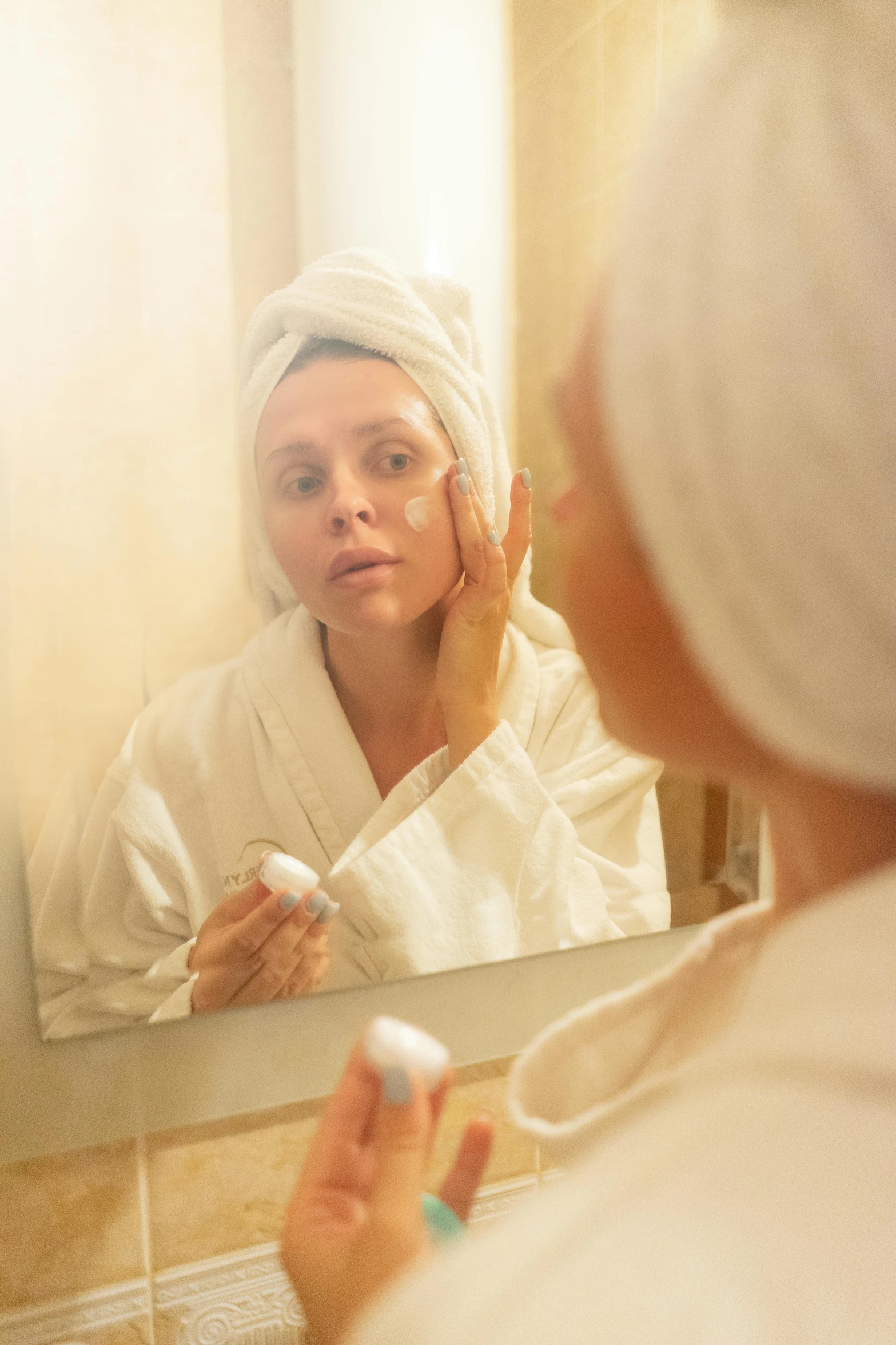 a woman brushing her teeth in front of a mirror, a portrait, by Julian Allen, shutterstock, renaissance, wearing a white bathing cap, hotel room, splash image, taken at golden hour