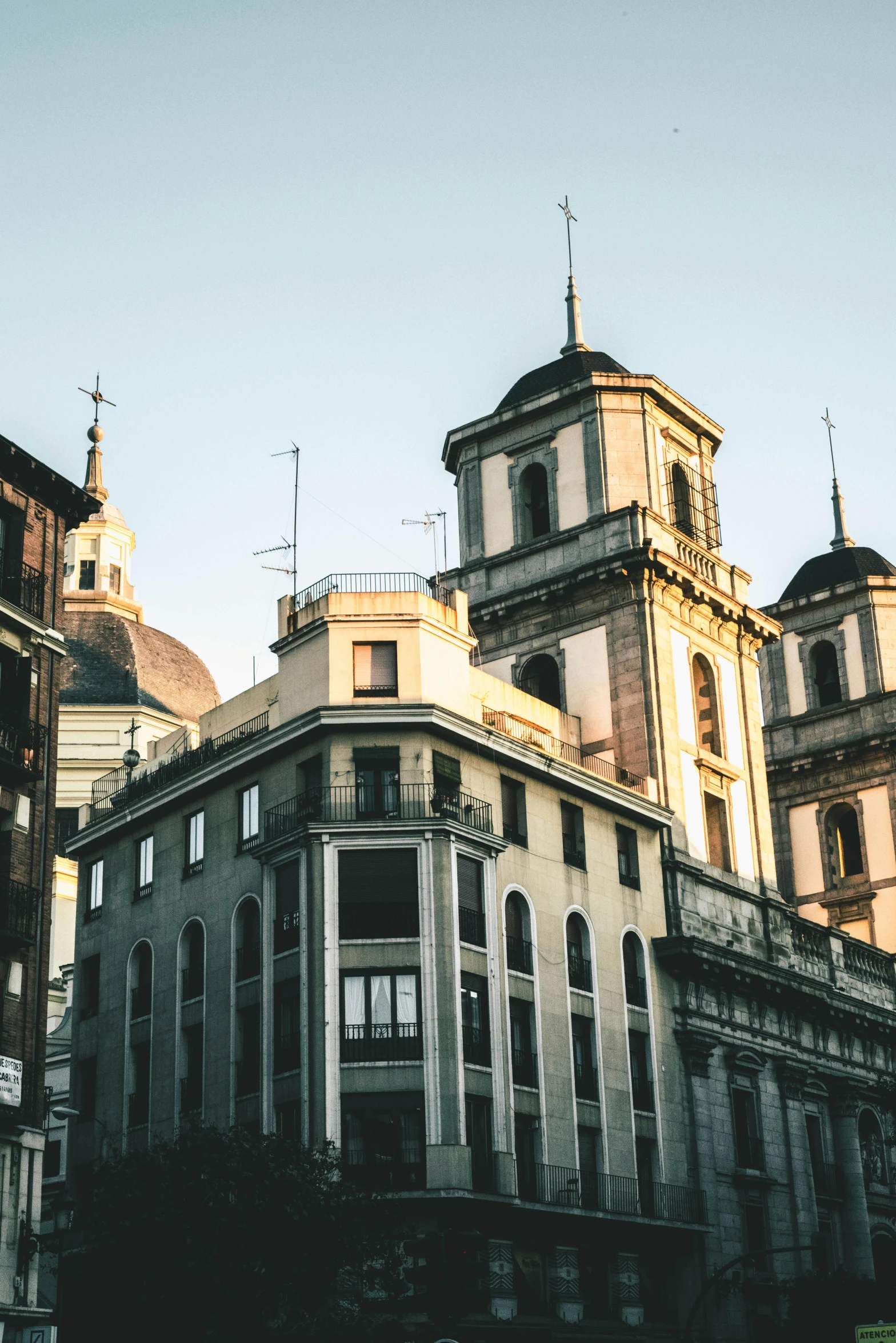 a couple of buildings that are next to each other, inspired by Lajos Berán, trending on unsplash, baroque, madrid, late afternoon, neoclassical tower with dome, tenement buildings