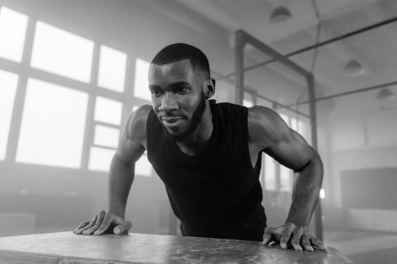 a black and white photo of a man doing push ups, a portrait, by Daniel Gelon, mkbhd, portrait shot 8 k, working out, thin young male